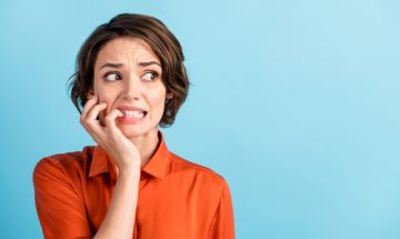 Woman contemplates mistakes about portable restroom rental planning