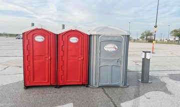 Standard Porta Potty and Handicap Porta Potty rental with Hand Sanitizer placed on the side